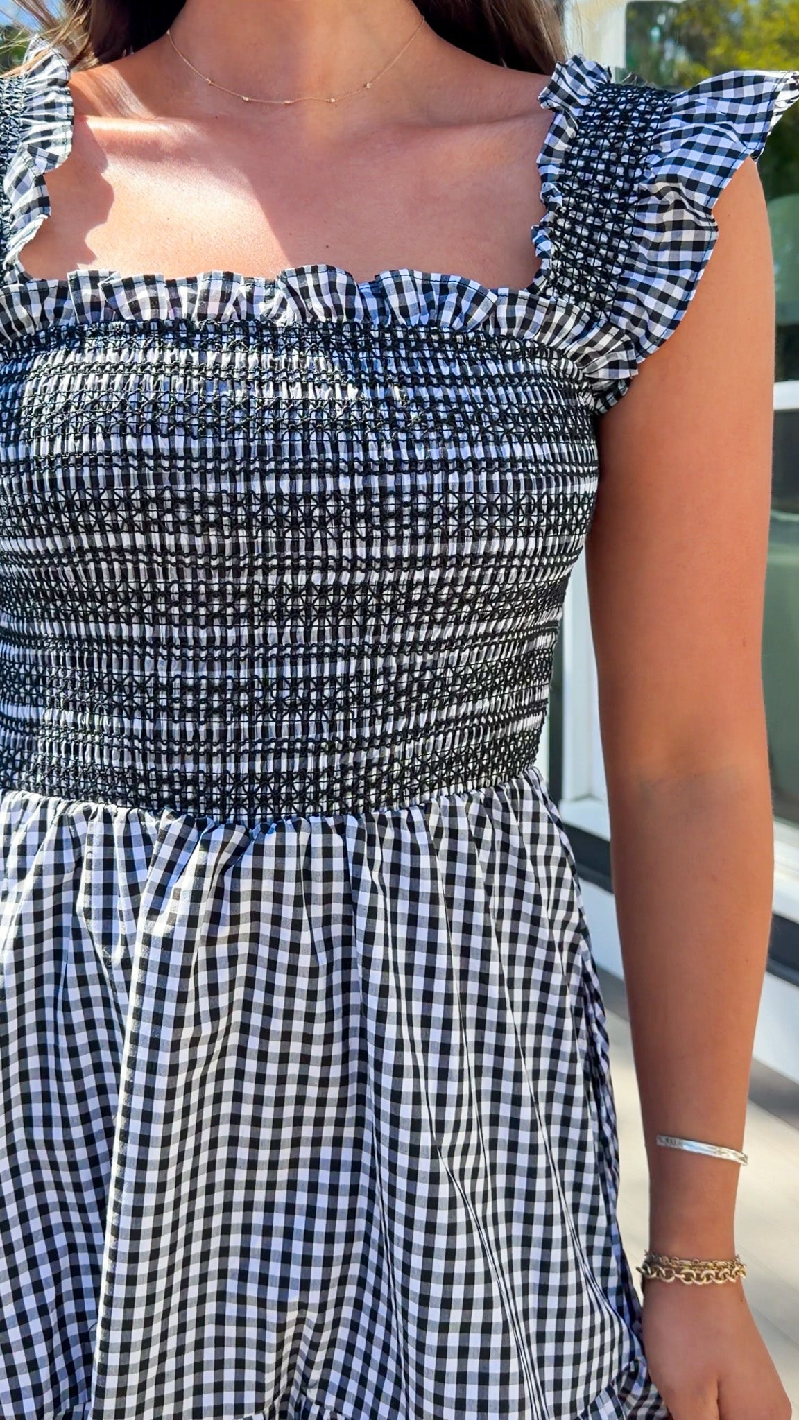 black and white gingham smocked mini dress with ruffle straps and flowy skirt and built in shorts