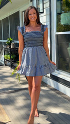 black and white gingham smocked mini dress with ruffle straps and flowy skirt and built in shorts