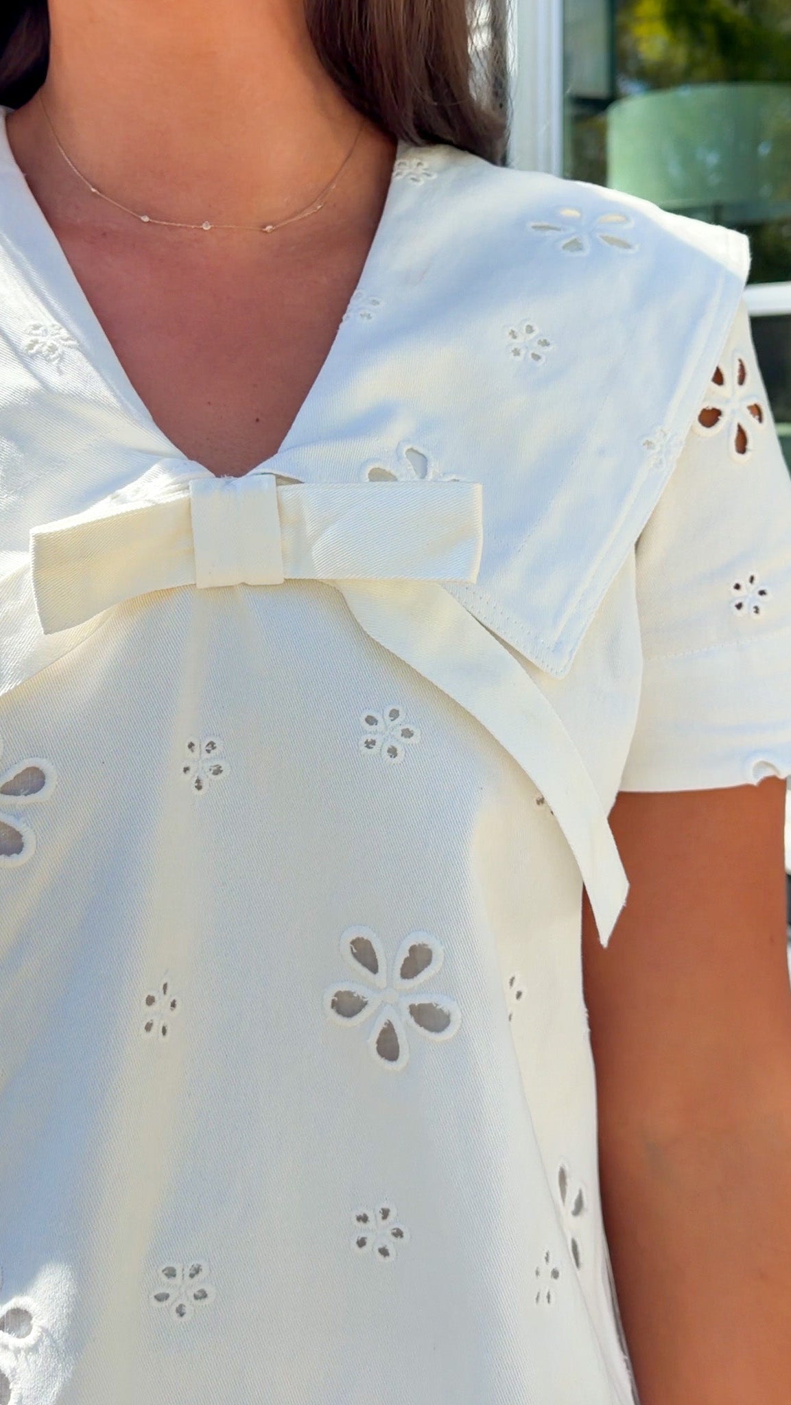 white eyelet mini dress with sailor collar bow tie detail and short sleeves
