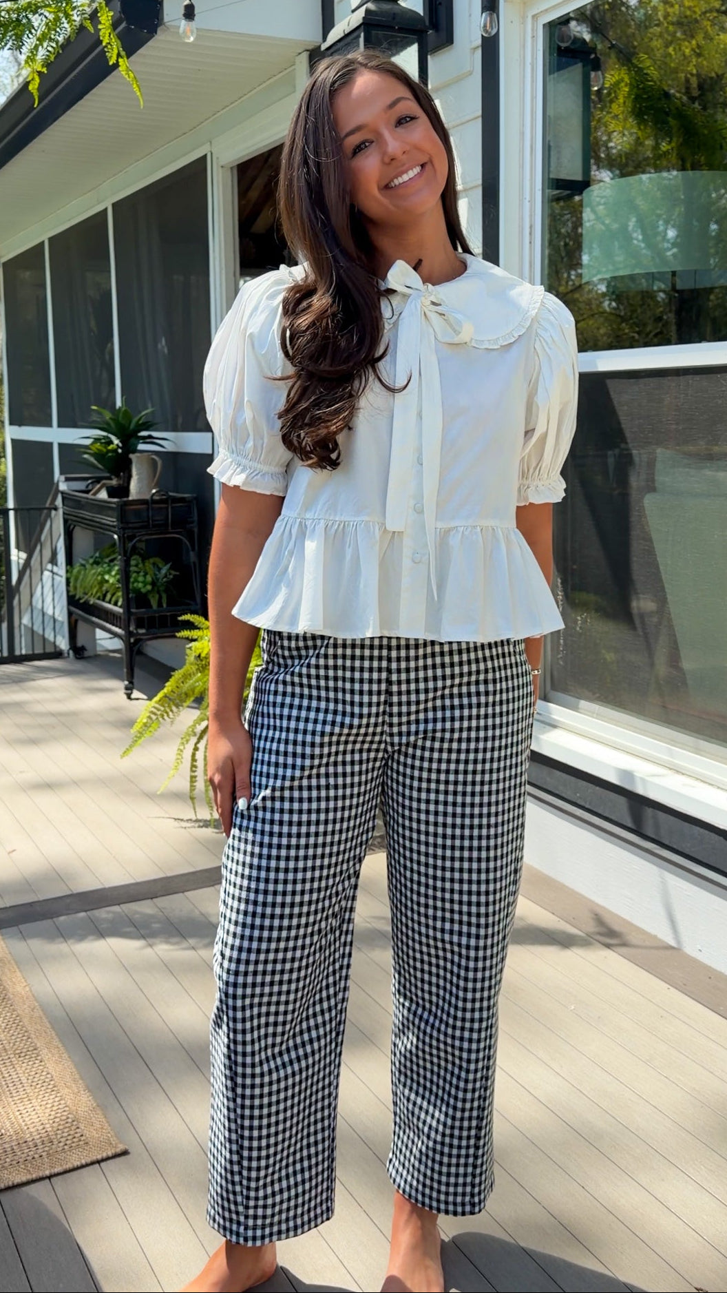 white cotton blouse with peter pan collar, puff sleeves, tie front bow and peplum hem