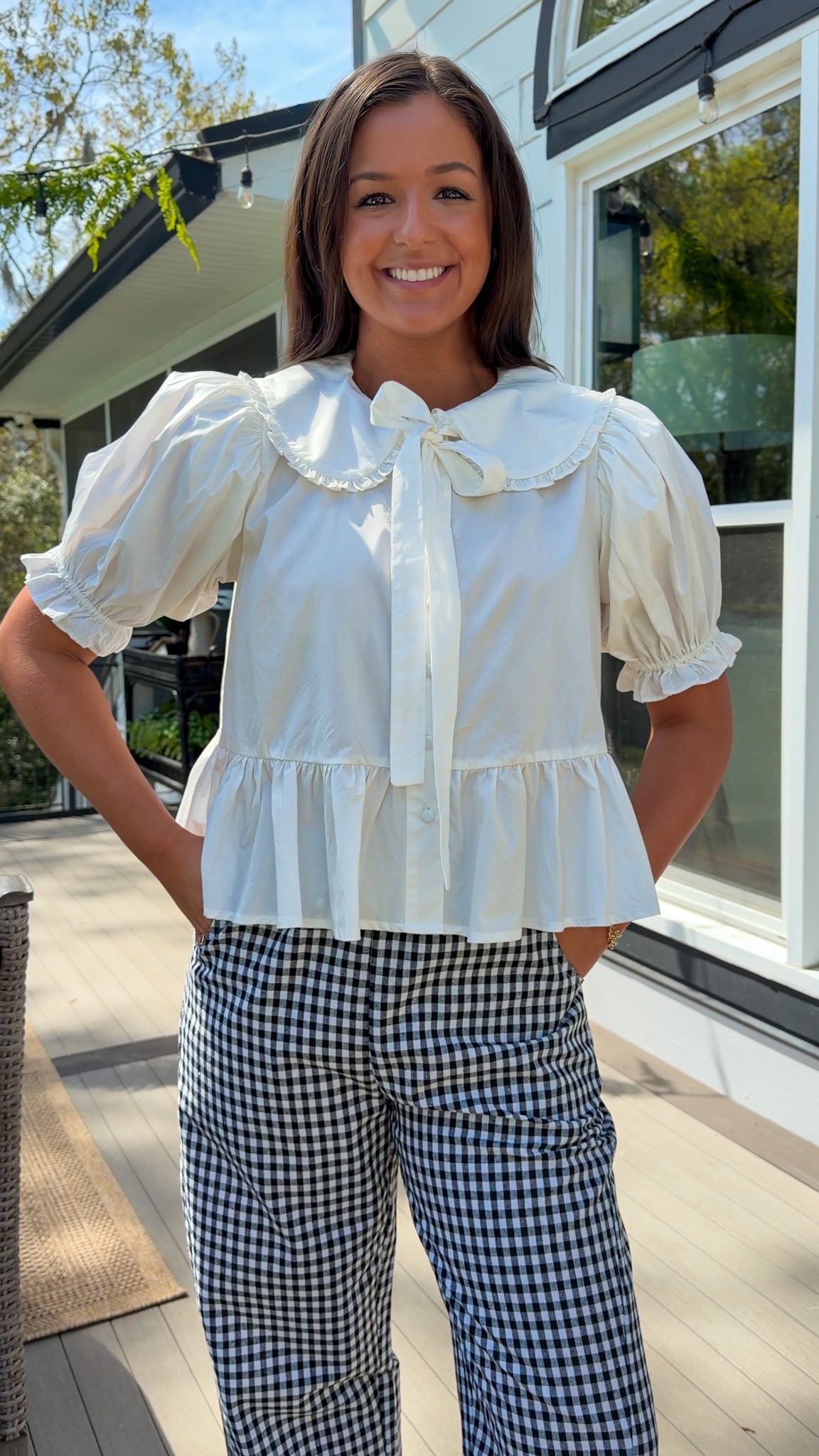 white cotton blouse with peter pan collar, puff sleeves, tie front bow and peplum hem