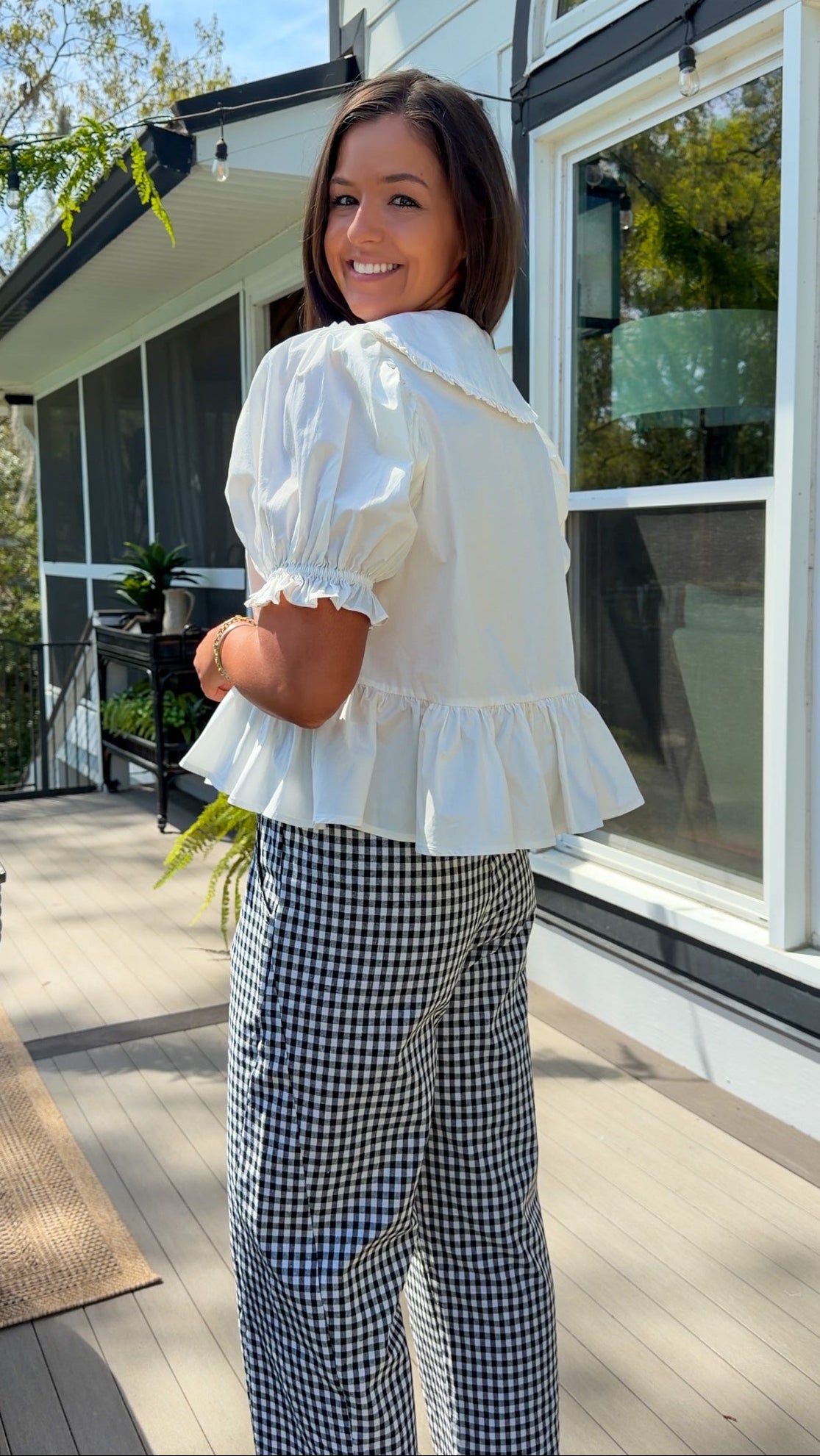 white cotton blouse with peter pan collar, puff sleeves, tie front bow and peplum hem