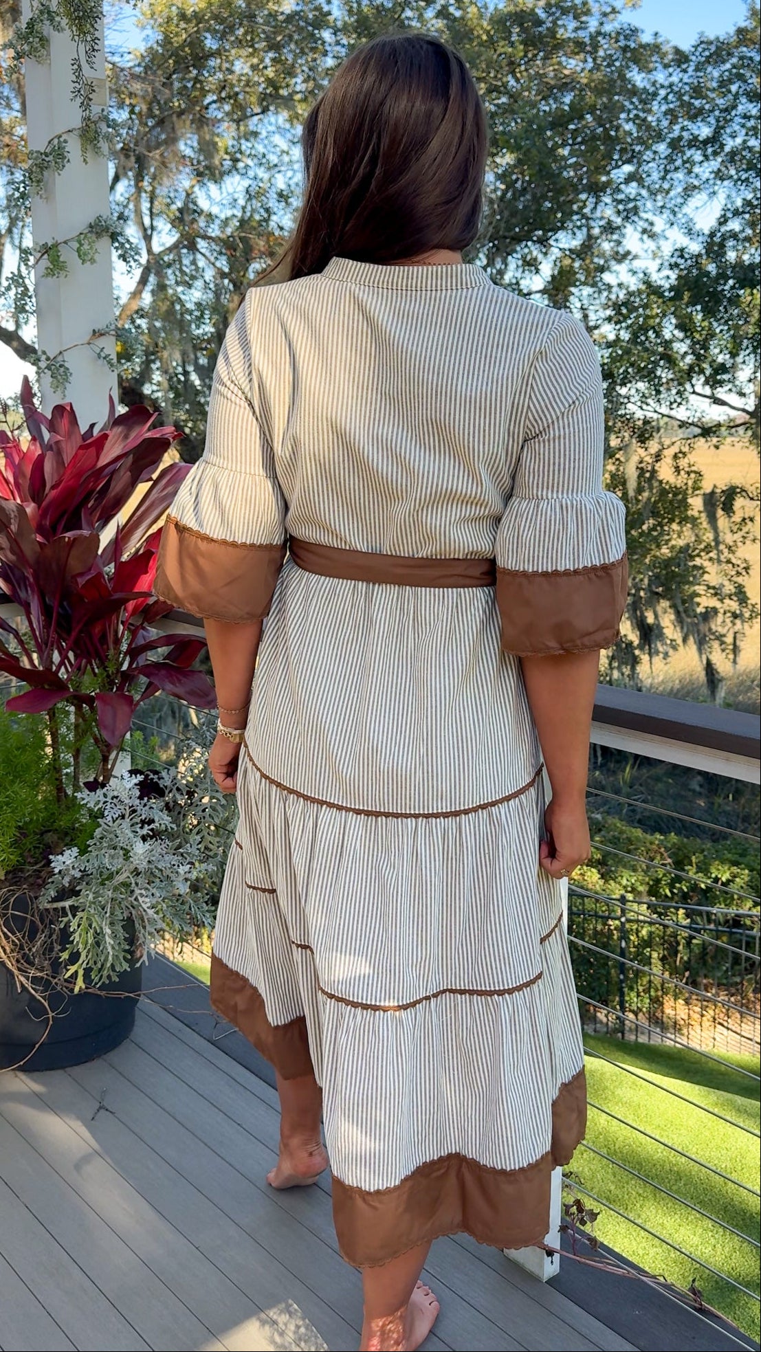 beige midi dress with brown stripes and details and belt back