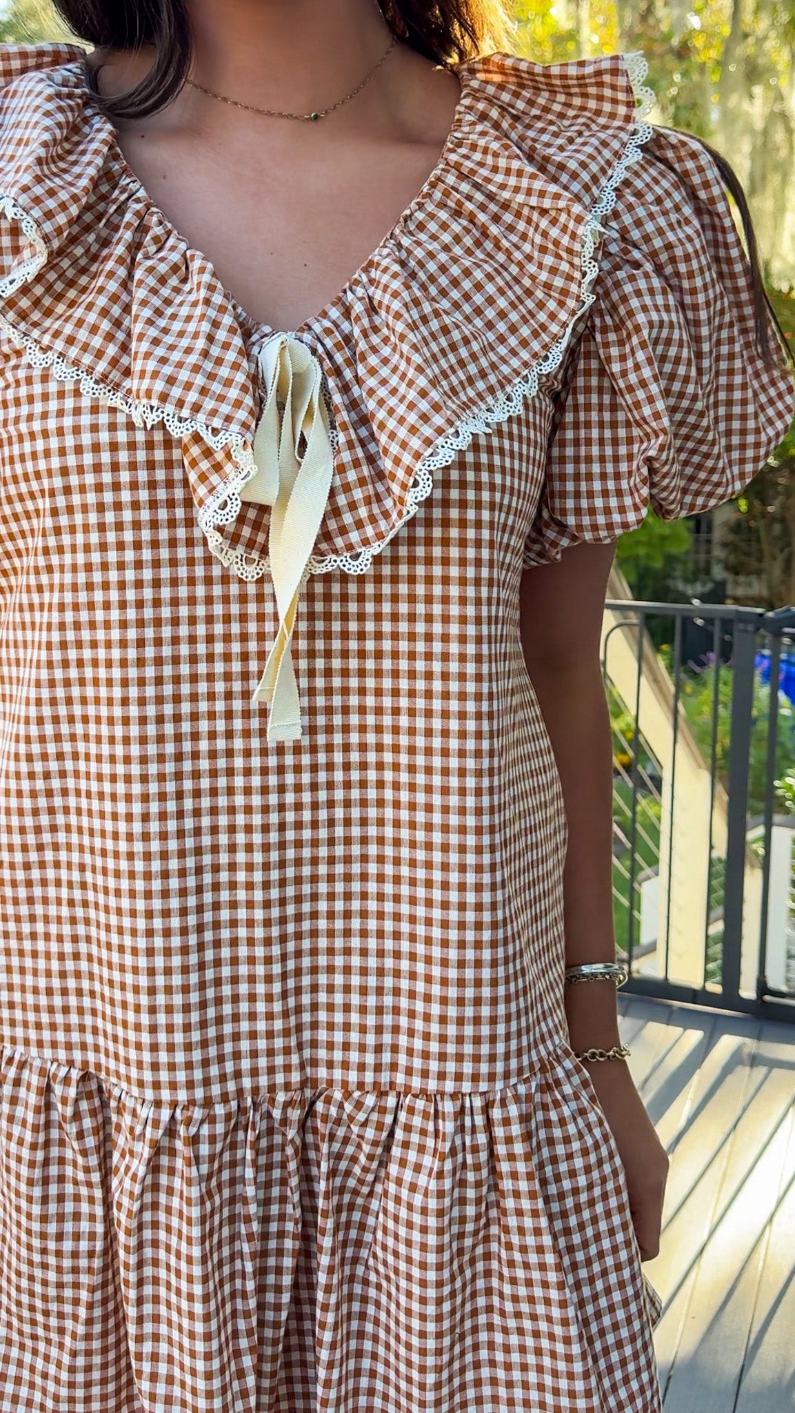 gingham orange and brown mini dress with ruffle collar and lace trim front close view