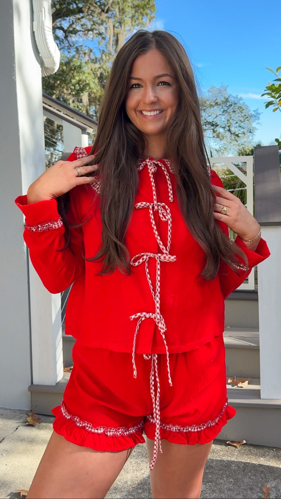 red velvet long sleeve top and short pajama set with gingham oversized peter pan collar and ruffle trim on shorts christmas pajamas bows  closer
