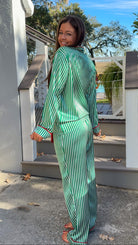 satin green stripe christmas pajama set with red velvet details and belt pant set button down closure long sleeve side view