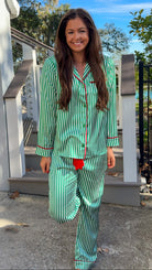 satin green stripe christmas pajama set with red velvet details and belt pant set button down closure long sleeve front