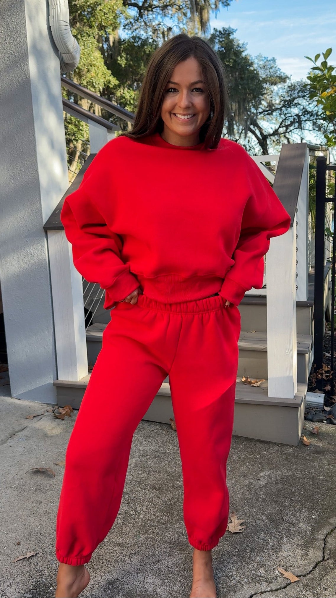 matching red sweatpants and sweatshirt comfy cozy loungewear. elastic waist band and slightly cropped oversized long sleeve top pant