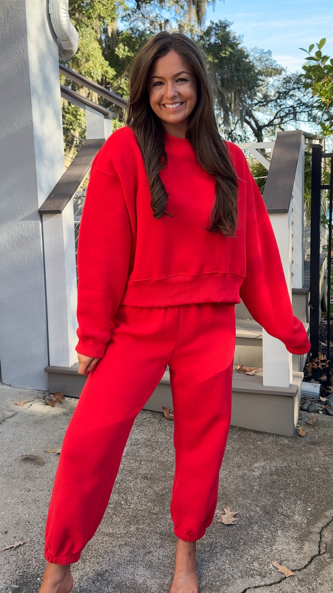matching red sweatpants and sweatshirt comfy cozy loungewear. elastic waist band and slightly cropped oversized long sleeve top