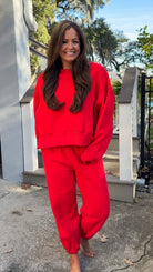 matching red sweatpants and sweatshirt comfy cozy loungewear. elastic waist band and slightly cropped oversized long sleeve top far 2