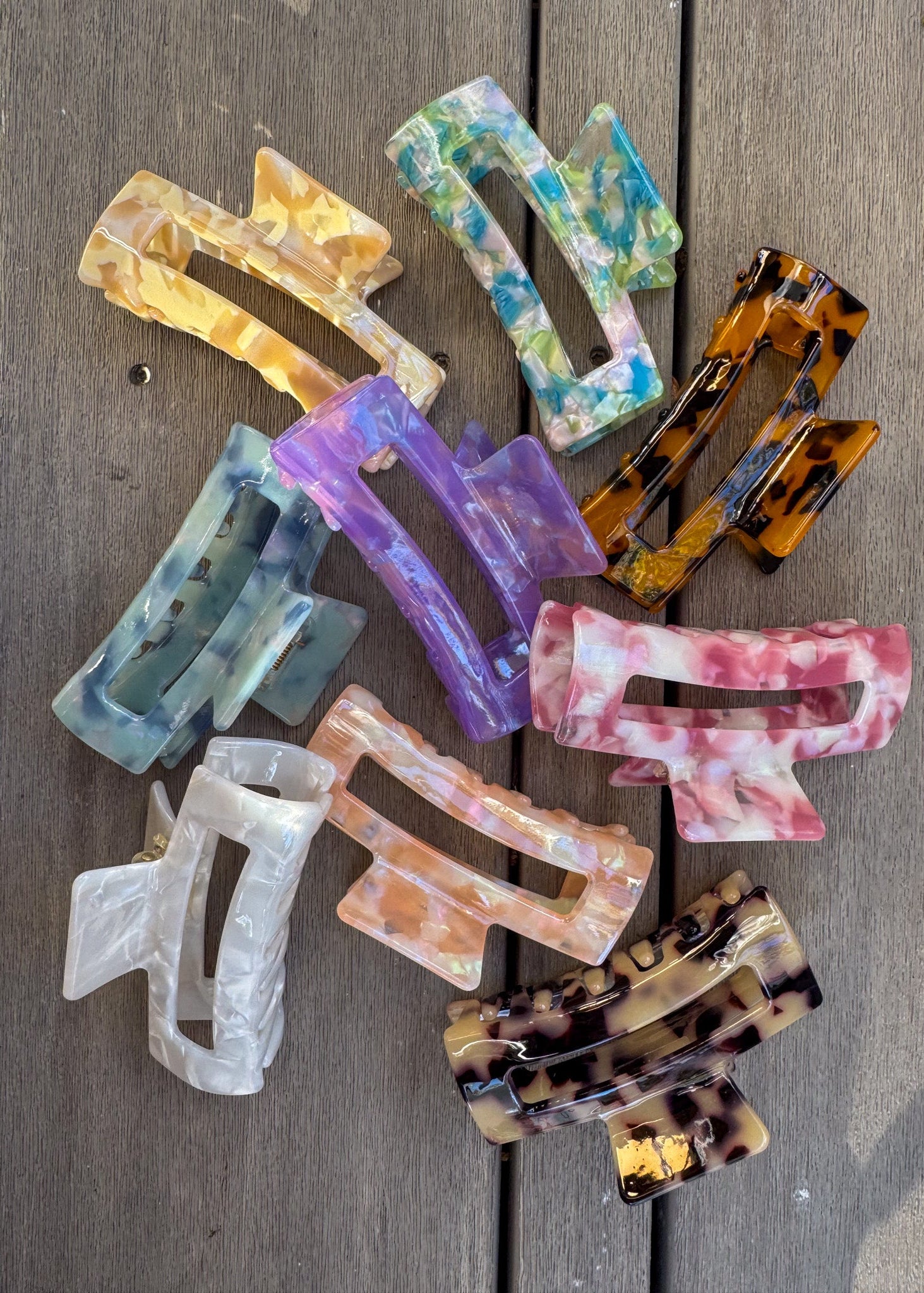 Colorful hair clips on a wooden surface