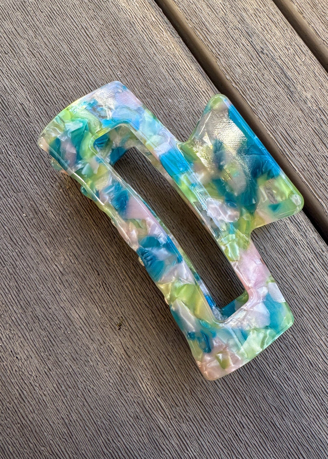 Colorful plastic buckle on a wooden surface