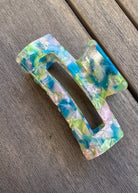 Colorful plastic buckle on a wooden surface