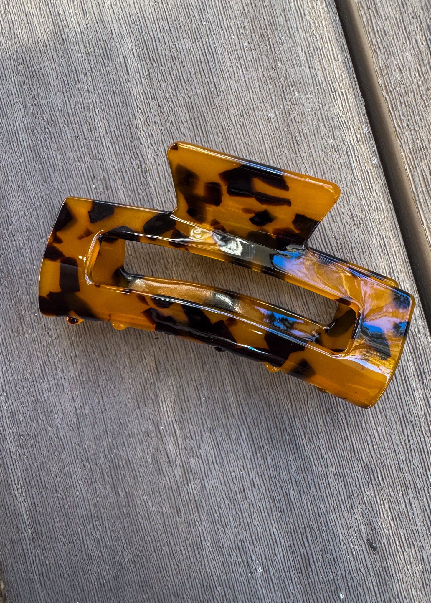 Tortoiseshell hair clip on a gray surface