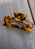 Tortoiseshell hair clip on a gray surface