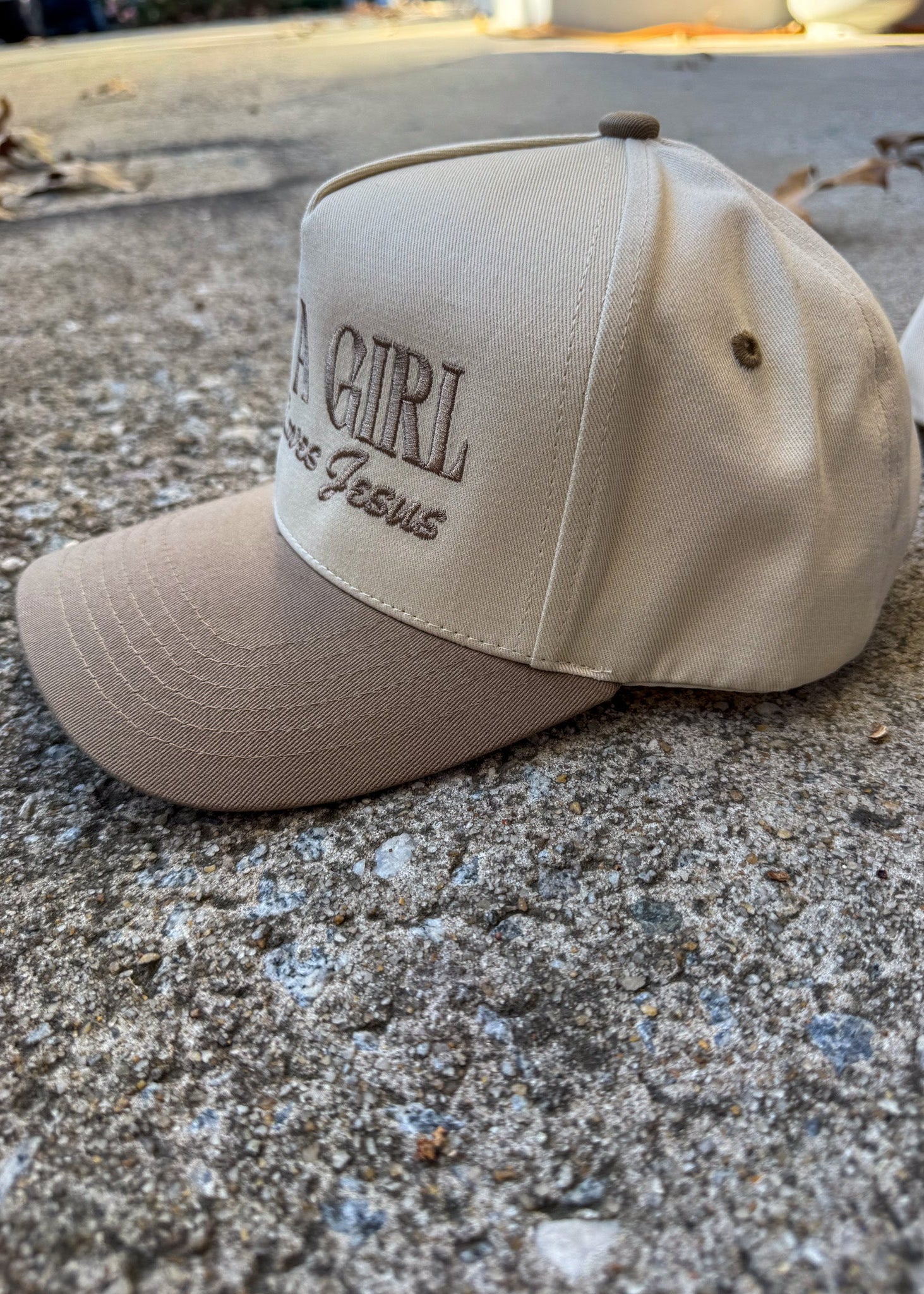 Beige cap with text on a concrete surface