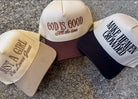 Cap with 'God is Good All the time' text on a concrete surface, trucker hat, christian trucker hat, hat with Just a Girl who loves Jesus, and Make Heaven Crowded. embroidered trucker hats