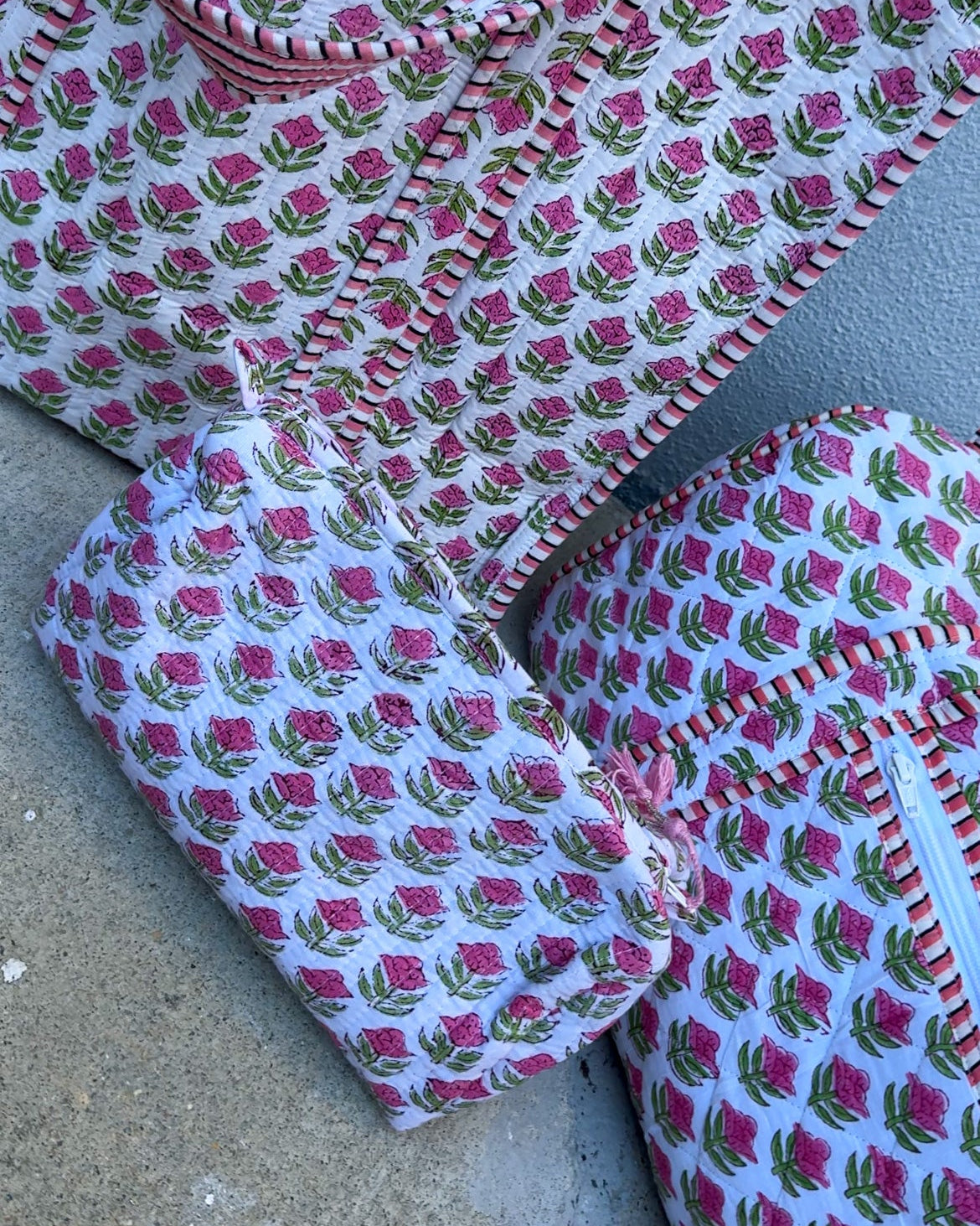 Set of fabric pieces with pink floral pattern on a gray surface