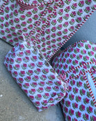 Set of fabric pieces with pink floral pattern on a gray surface