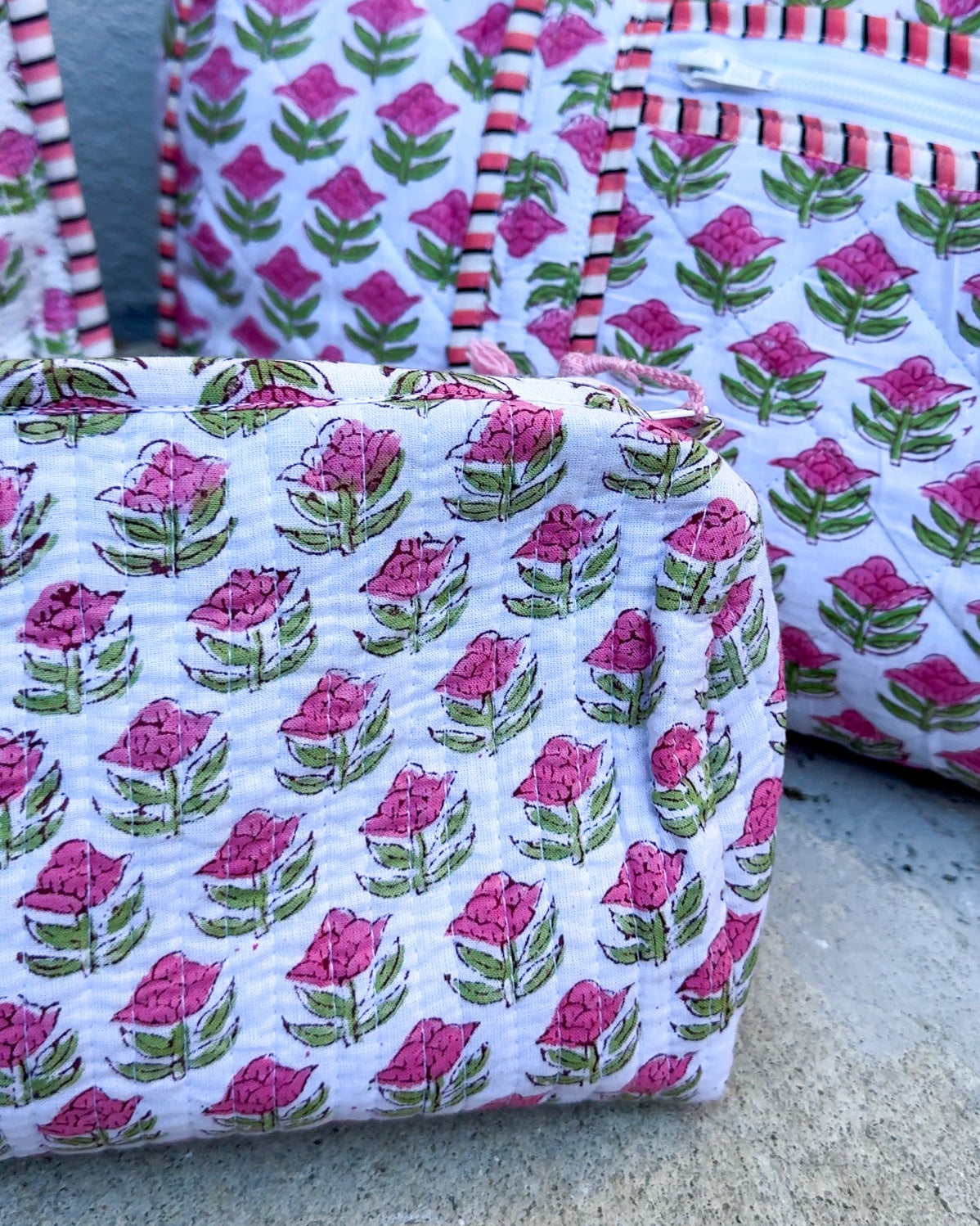 Fabric bags with floral pattern on a concrete surface