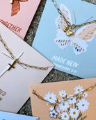 Set of cards with butterfly and floral designs on a textured surface