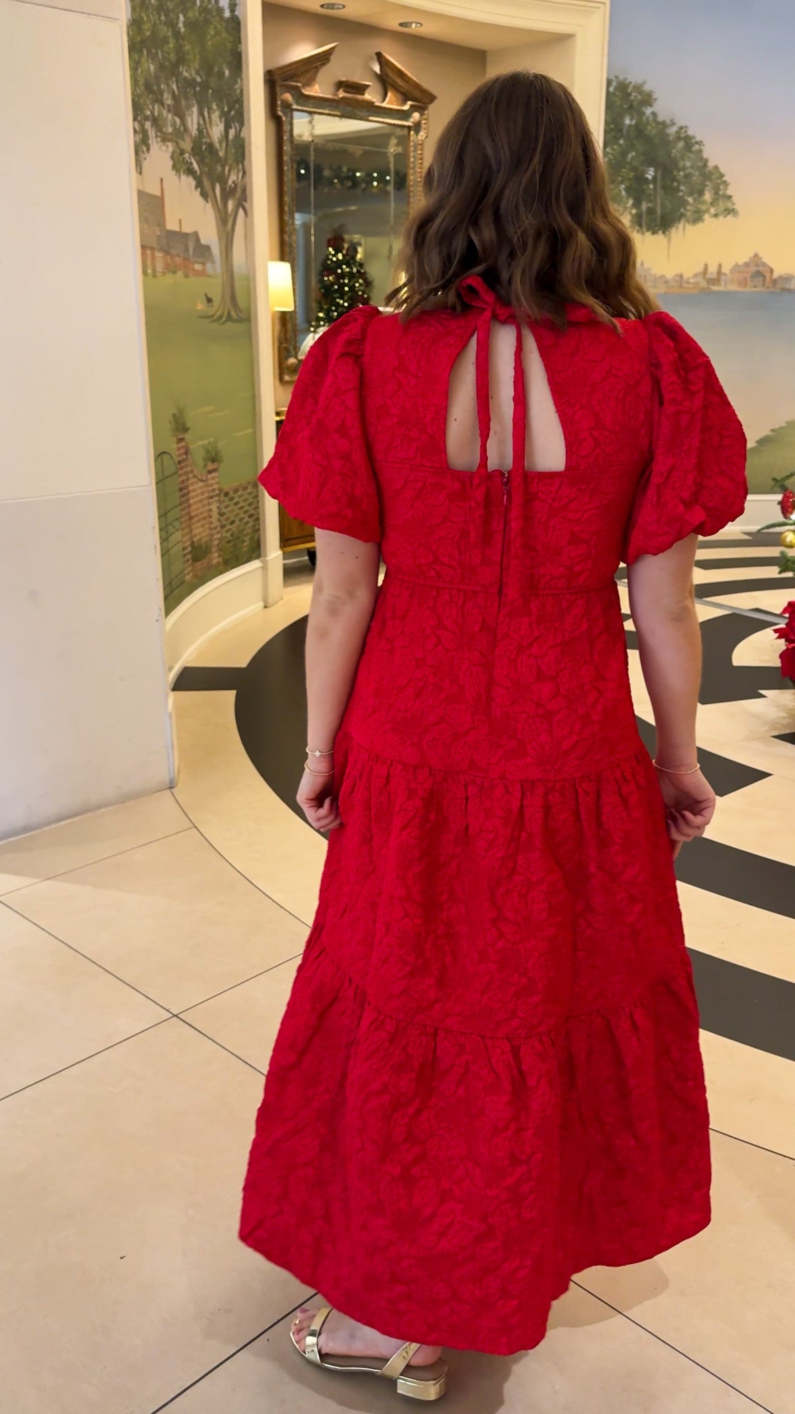 red jacquard maxi dress with puff sleeves and tiered skirt bottom and open back tie bow v neck holiday christmas dress