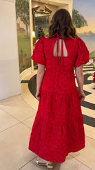red jacquard maxi dress with puff sleeves and tiered skirt bottom and open back tie bow v neck holiday christmas dress