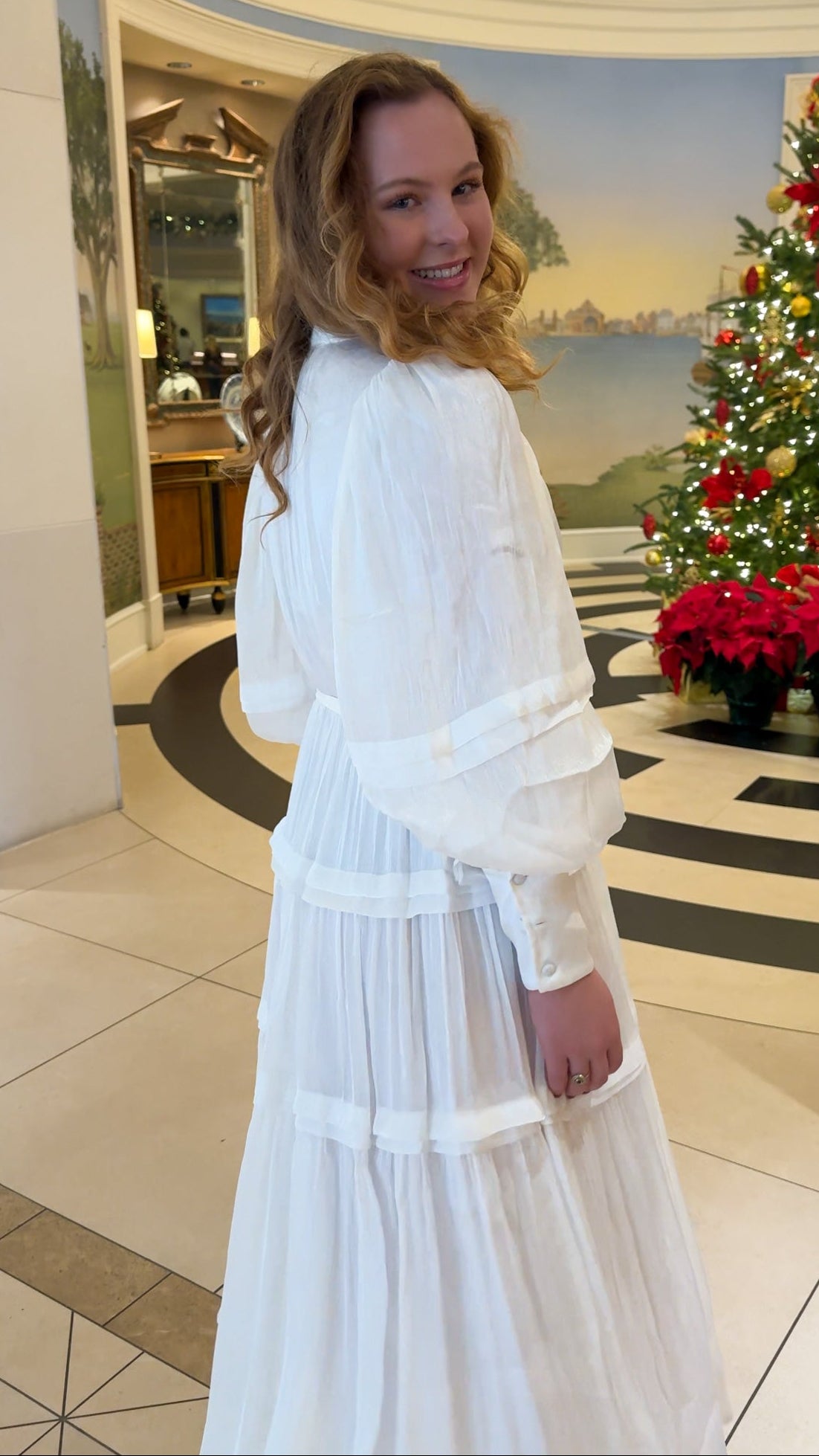 Shimmer crinkled long sleeve tiered midi dress with V-neckline, stand collar, waist tie belt, and flowing skirt.