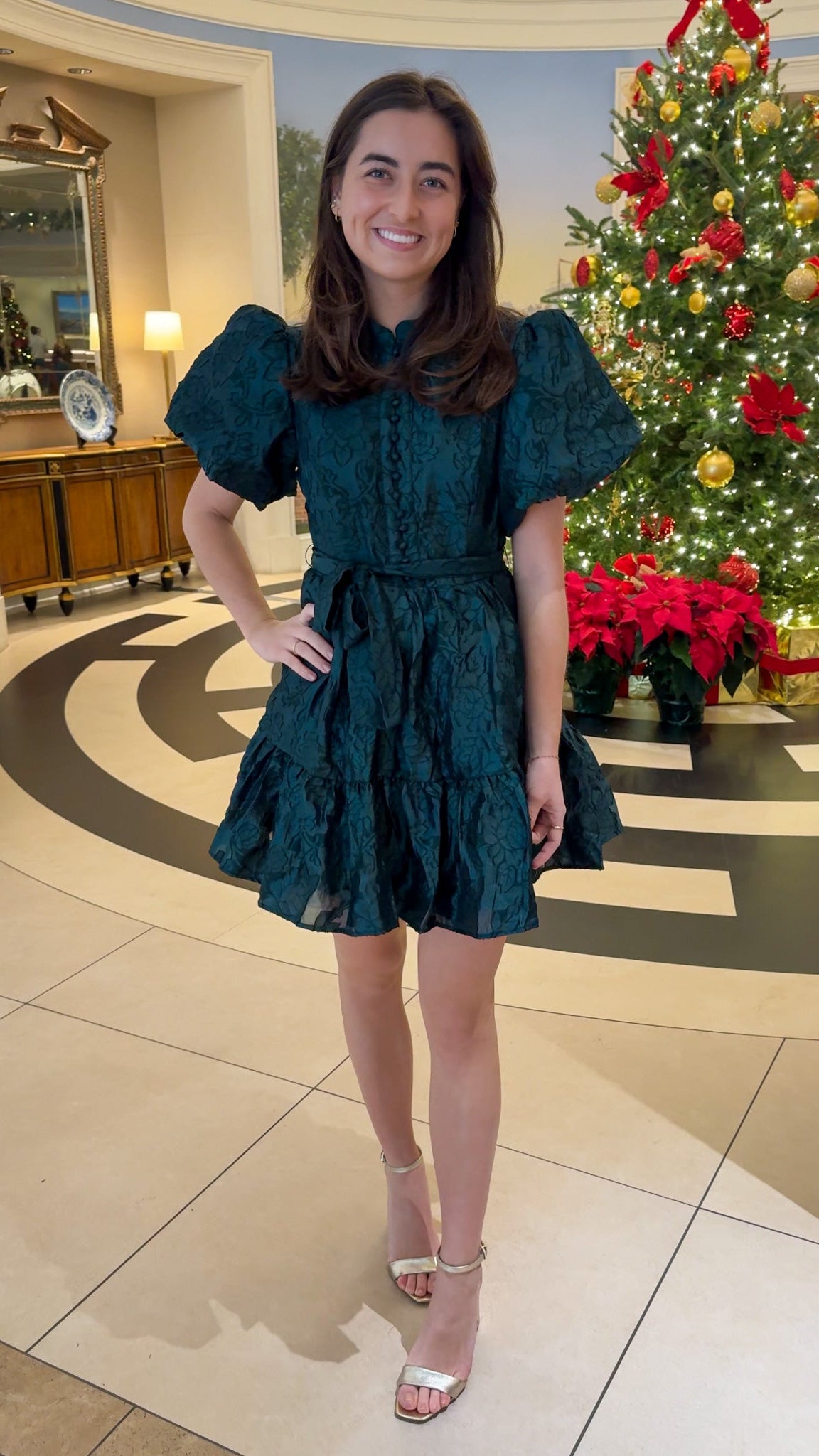 Hunter green floral textured mini dress with puff sleeves, covered button details, tie waist, and tiered skirt.