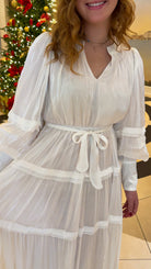 Shimmer crinkled long sleeve tiered midi dress with V-neckline, stand collar, waist tie belt, and flowing skirt.