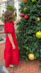 red jacquard maxi dress with puff sleeves and tiered skirt bottom and open back tie bow v neck holiday christmas dress