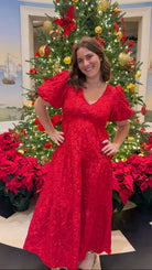red jacquard maxi dress with puff sleeves and tiered skirt bottom and open back tie bow v neck holiday christmas dress