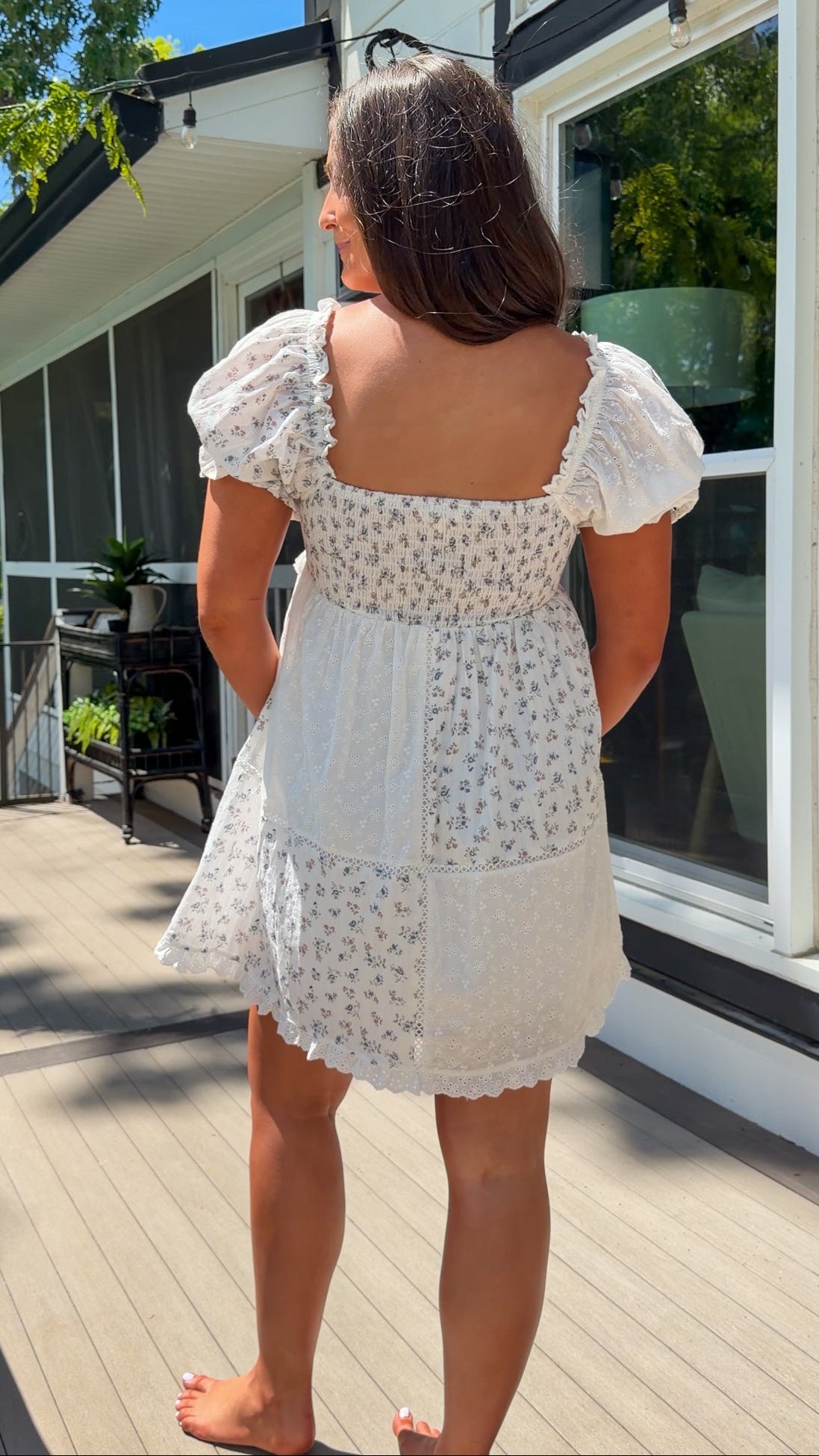 cream floral mini dress with eyelet lace, puff sleeves, scalloped neckline, and front tie detail