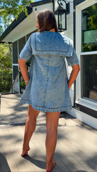 light wash denim mini dress with oversized collar, tie front detail, short sleeves, and slightly oversized fit