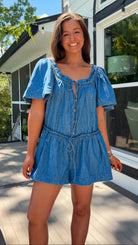 Denim romper with butterfly sleeves, tie neckline, and drawstring waist in blue