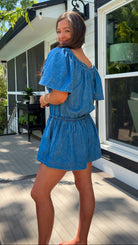 Denim romper with butterfly sleeves, tie neckline, and drawstring waist in blue