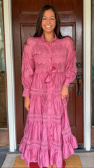 a satin midi dress with crochet lace panels, button-down front, long sleeves, and a self-tie waist in a soft plum color. pink mauve high neck 