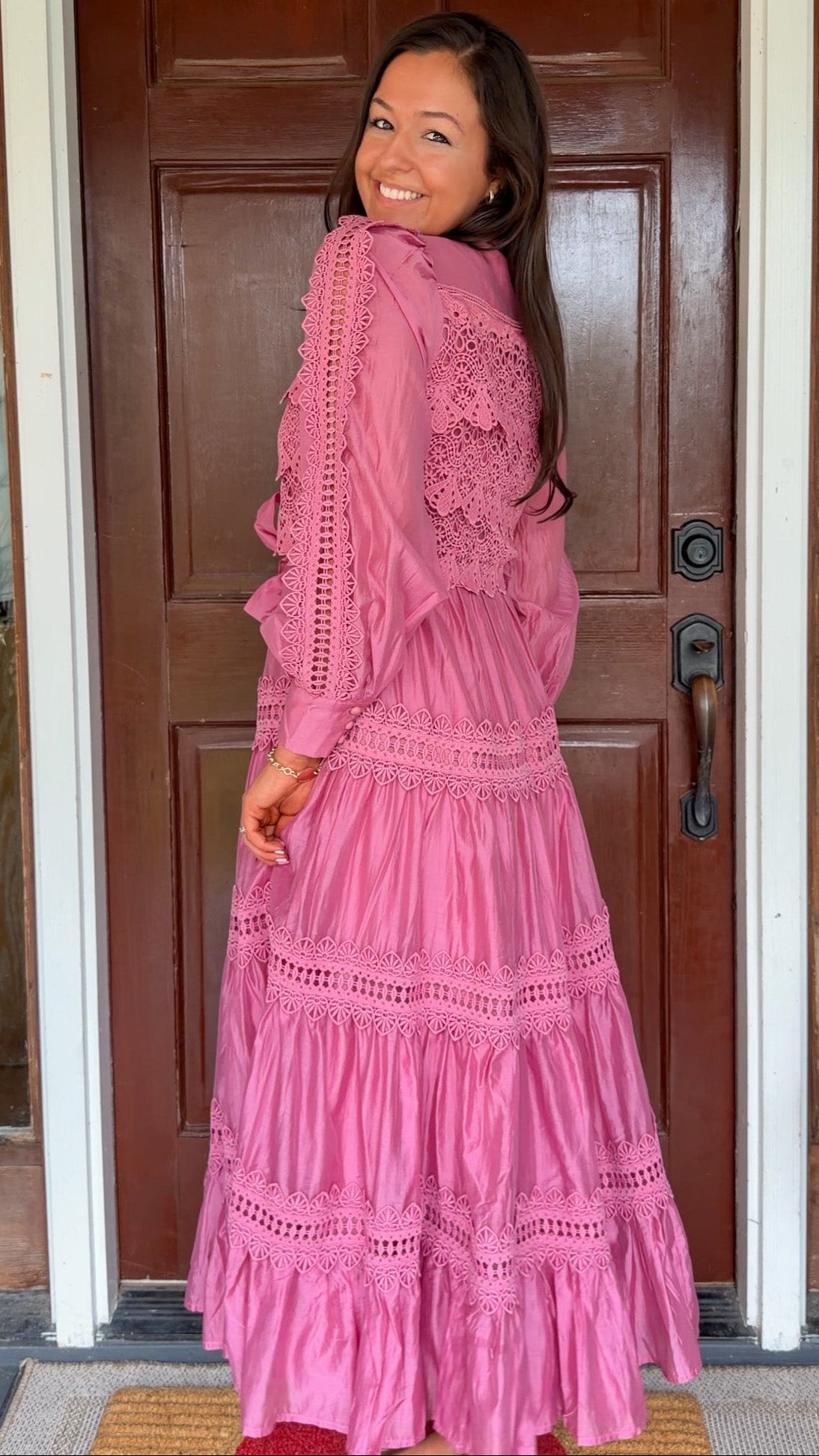 a satin midi dress with crochet lace panels, button-down front, long sleeves, and a self-tie waist in a soft plum color. pink mauve high neck 