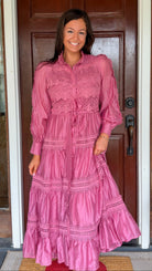 a satin midi dress with crochet lace panels, button-down front, long sleeves, and a self-tie waist in a soft plum color. pink mauve high neck 