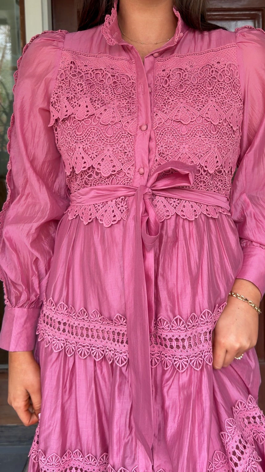 a satin midi dress with crochet lace panels, button-down front, long sleeves, and a self-tie waist in a soft plum color. pink mauve high neck 