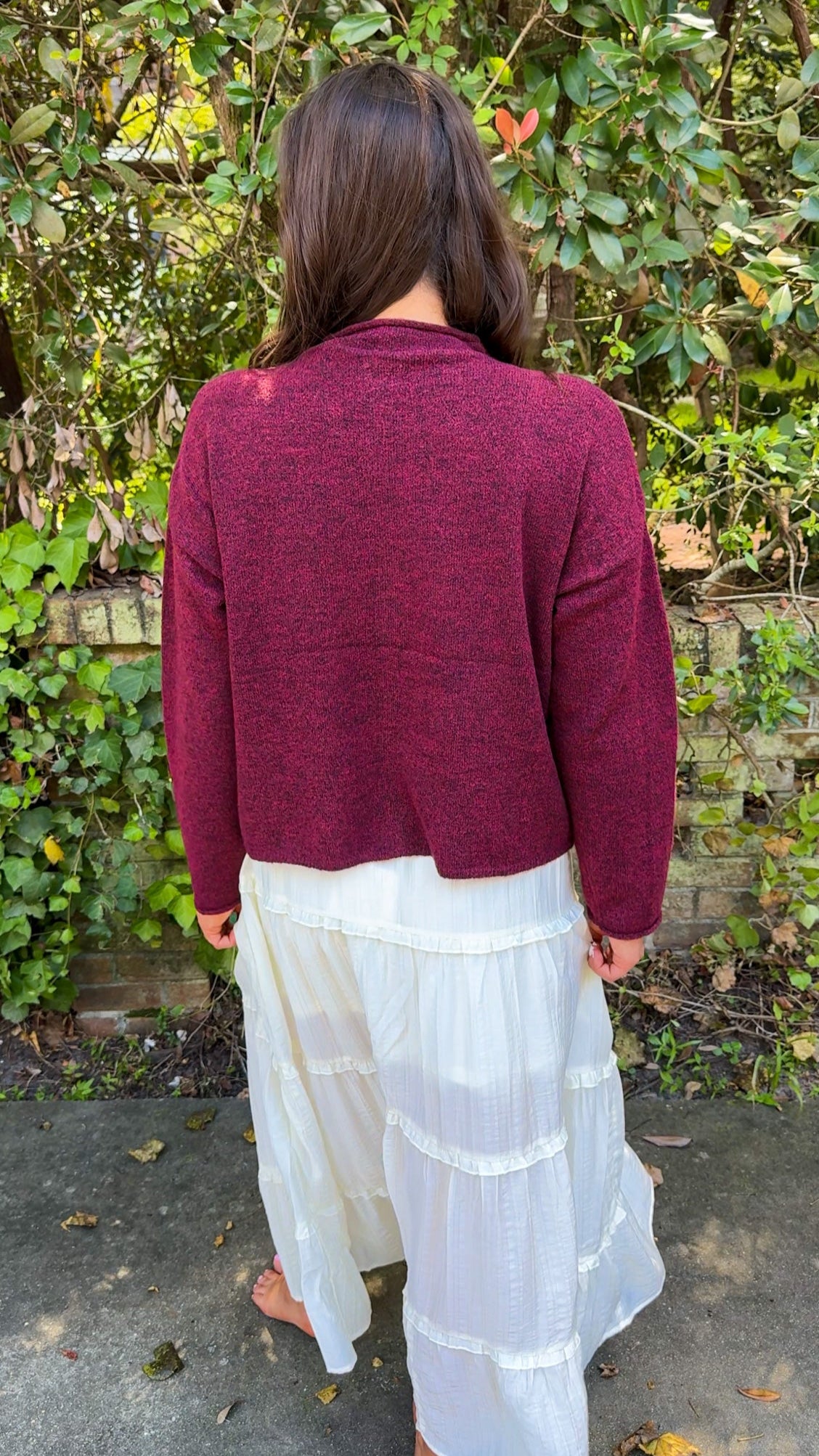 back  view of burgundy maroon cardigan and white flowy midi skirt 