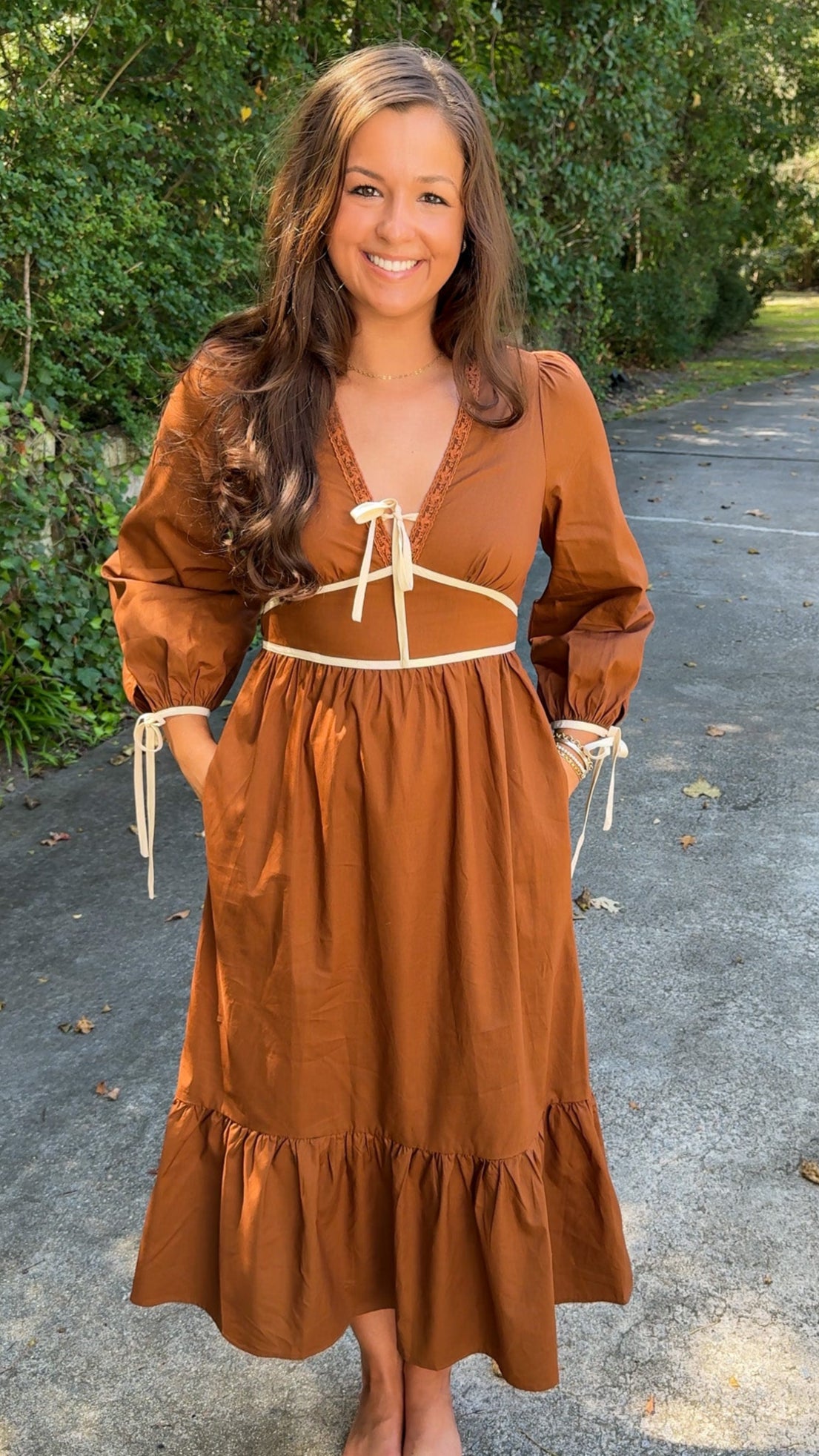 front view of orange brown rust midi dress with ivory cream details