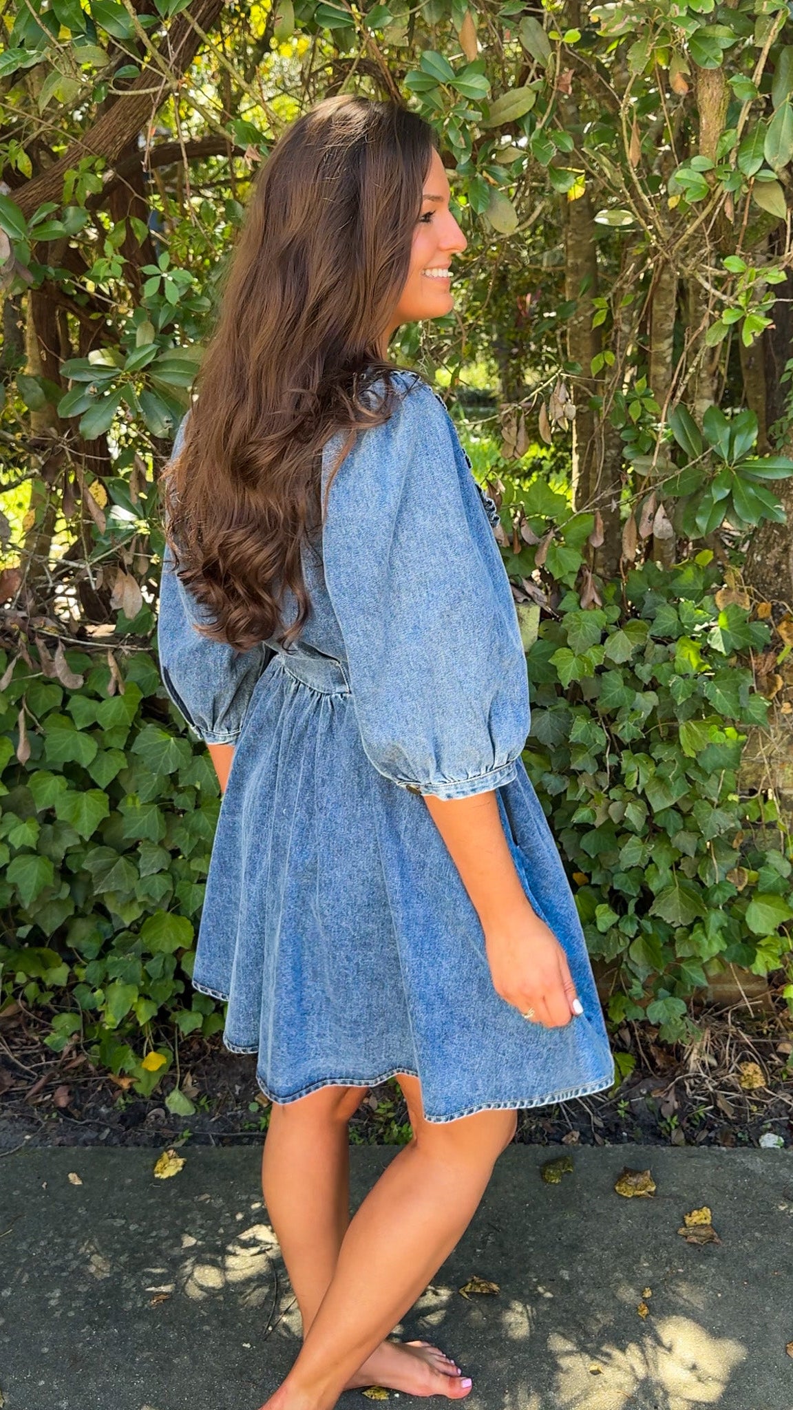 side view of denim mini dress with oversized collar and 3/4 sleeves