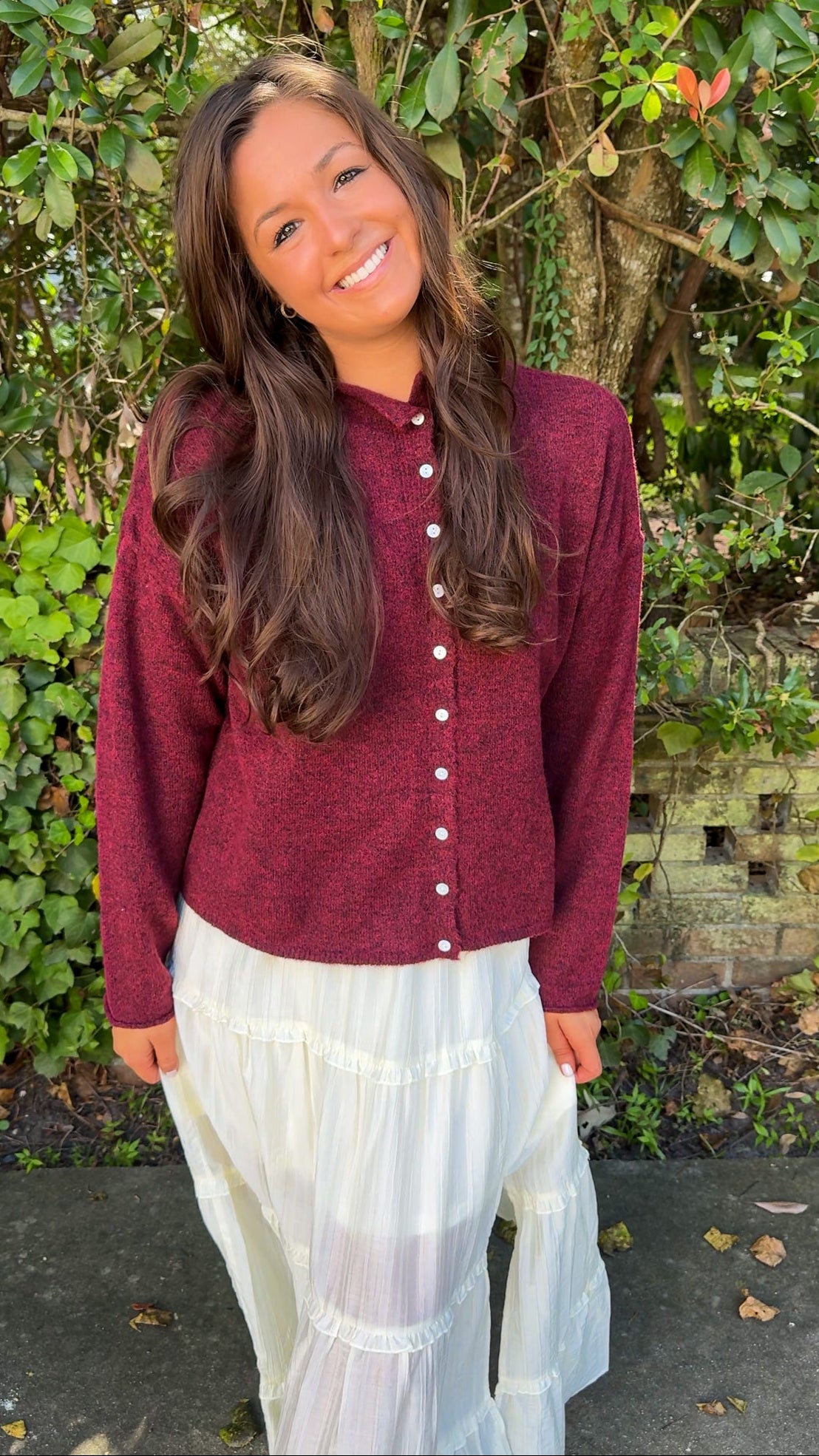 front view of burgundy maroon cardigan and white flowy midi skirt 
