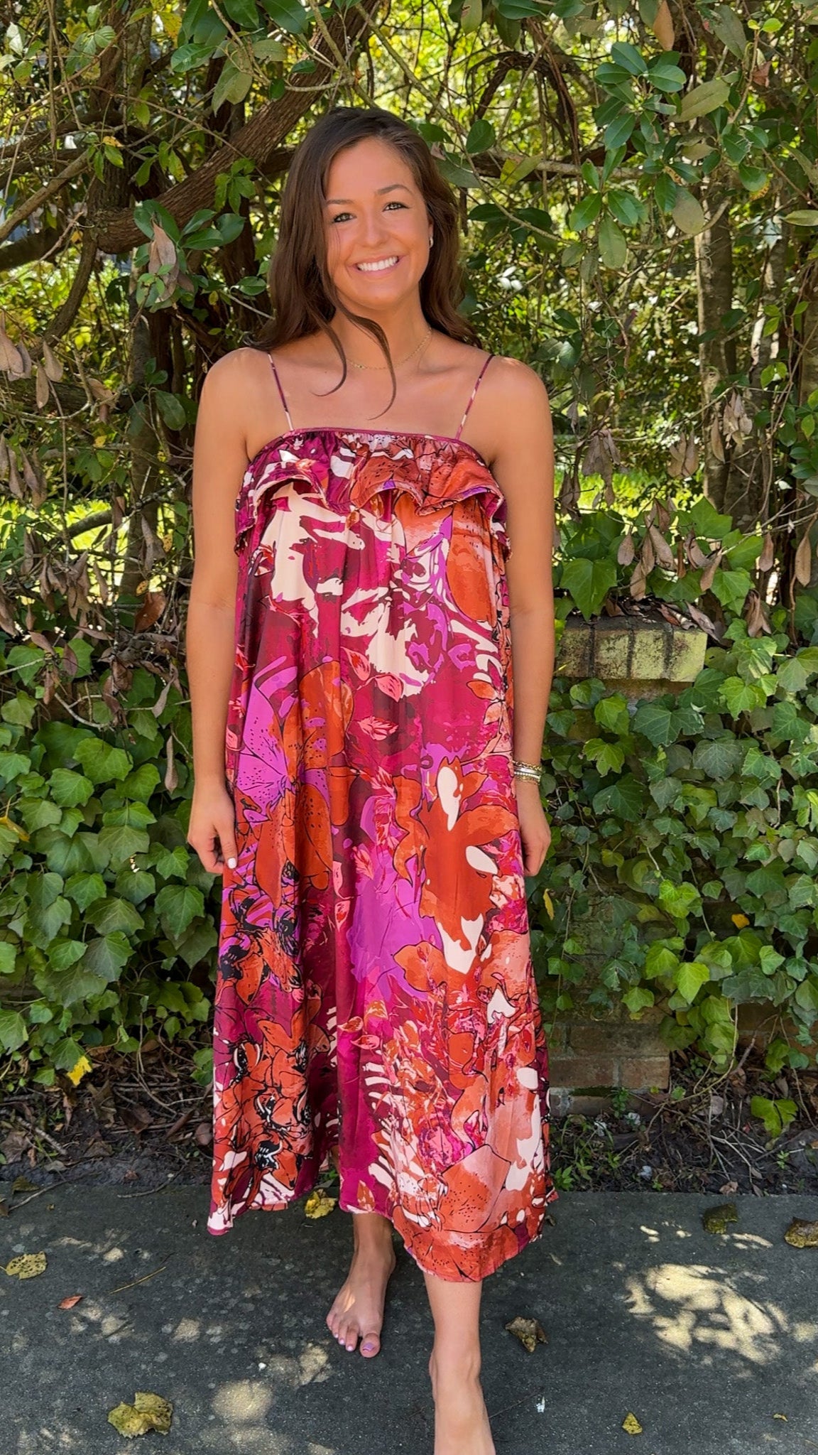 front far away view burgundy floral fall dress with spaghetti straps and ruffle top