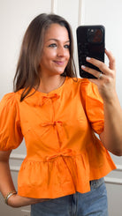 orange tie top blouse with puff sleeves