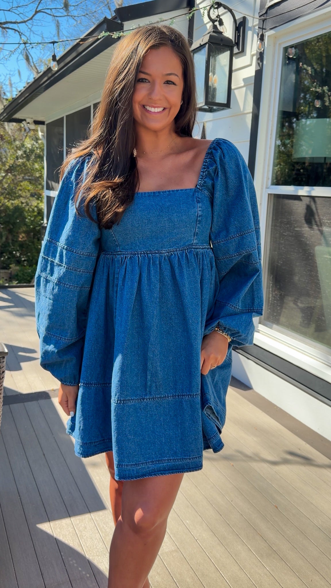 Women’s blue denim babydoll dress featuring a square neckline, long puff sleeves, and a loose, comfortable silhouette.
