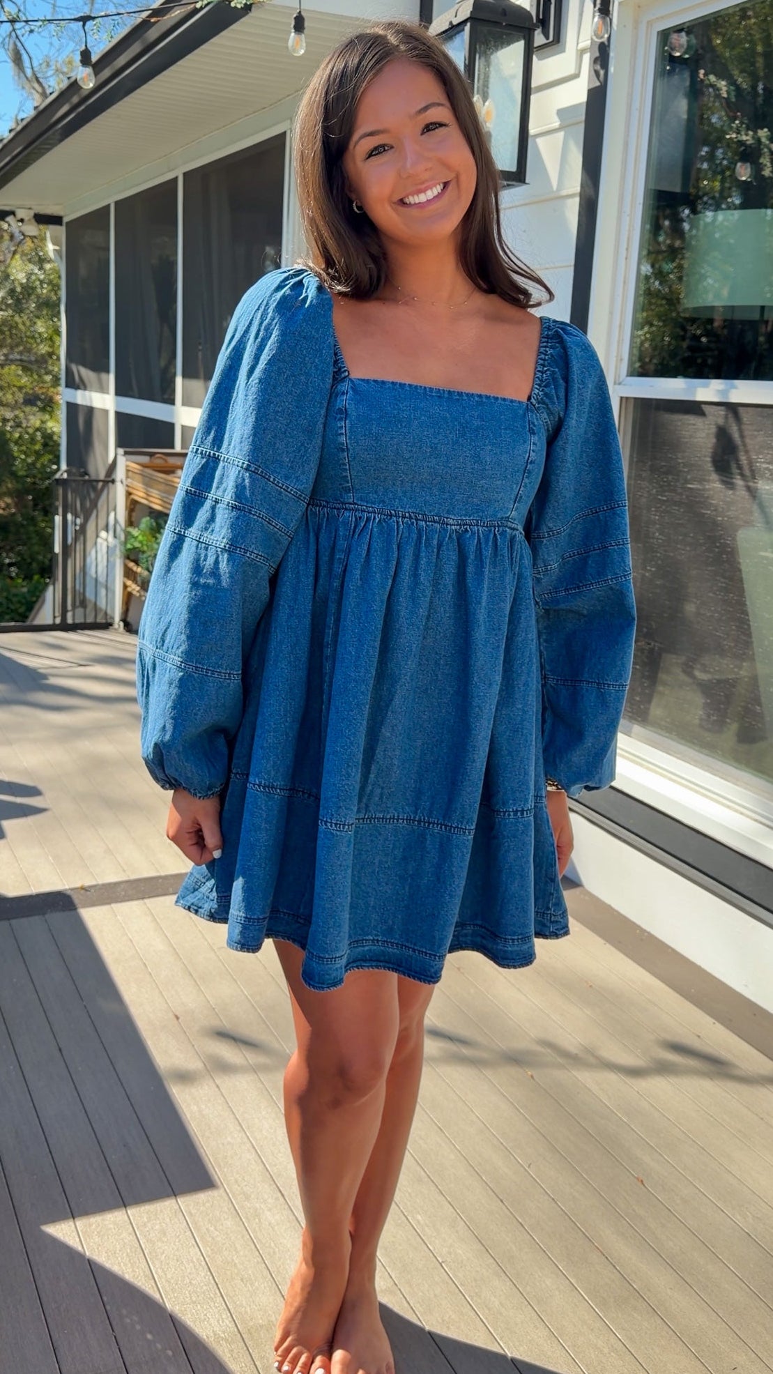 Women’s blue denim babydoll dress featuring a square neckline, long puff sleeves, and a loose, comfortable silhouette.