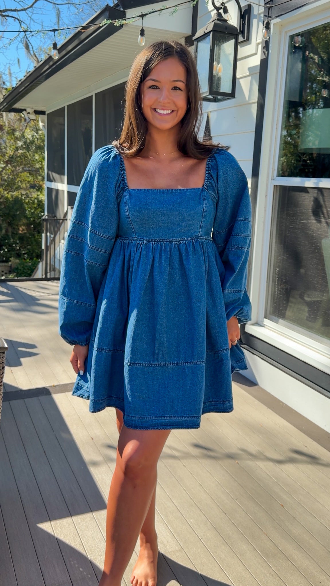 Women’s blue denim babydoll dress featuring a square neckline, long puff sleeves, and a loose, comfortable silhouette.