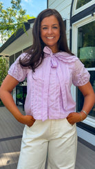 lilac top with eyelet puff sleeves and oversized collar button down closure